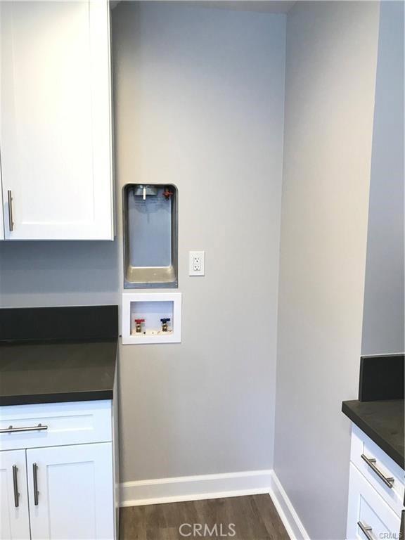539 E 223rd St, Carson, CA 90745 - washroom featuring hookup for a washing machine, cabinet space, baseboards, and dark wood-style floors