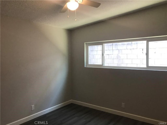 539 E 223rd St, Carson, CA 90745 - spare room with healthy amount of natural light, dark wood-style floors, a ceiling fan, baseboards, and a textured ceiling