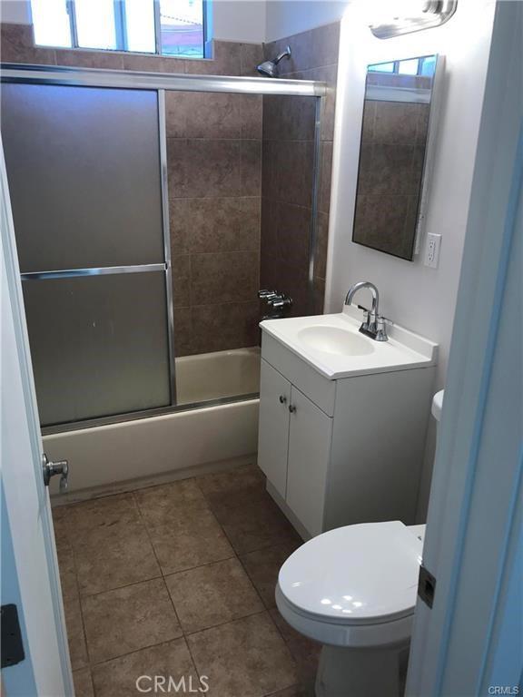 539 E 223rd St, Carson, CA 90745 - bathroom featuring vanity, toilet, shower / bath combination with glass door, and tile patterned floors