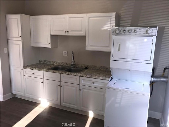 539 E 223rd St, Carson, CA 90745 - kitchen featuring stacked washing machine and dryer, white cabinets, and dark wood-style floors