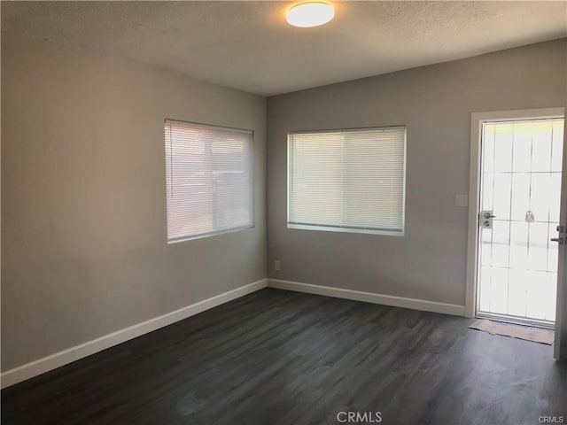539 E 223rd St, Carson, CA 90745 - unfurnished room featuring dark wood finished floors, baseboards, and a textured ceiling