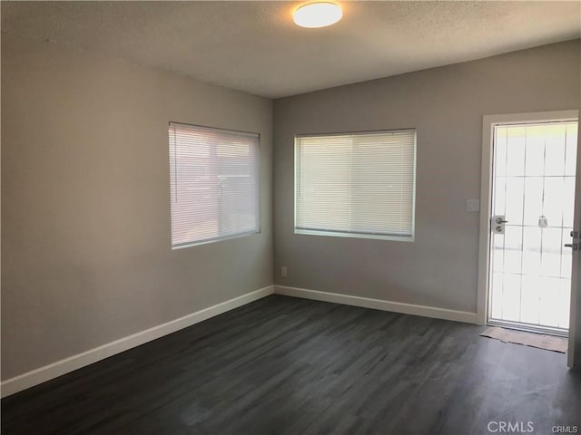 539 E 223rd St, Carson, CA 90745 - empty room with dark wood finished floors and a textured ceiling