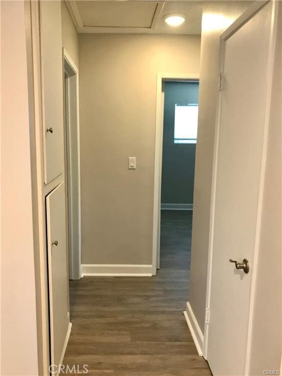539 E 223rd St, Carson, CA 90745 - hall featuring baseboards, dark wood finished floors, and attic access