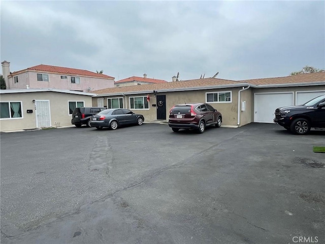 539 E 223rd St, Carson, CA 90745 - view of property with stucco siding, an attached garage, and asphalt driveway