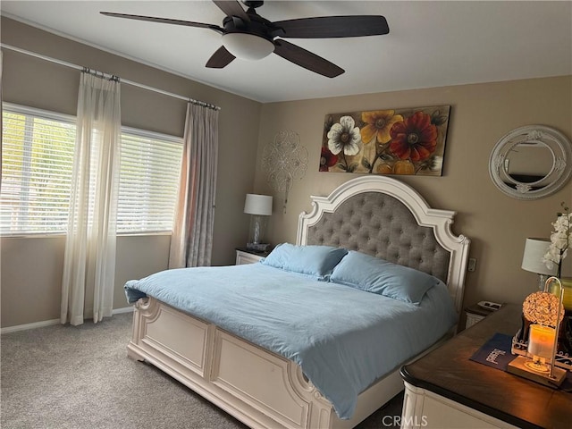 bedroom with baseboards, ceiling fan, and light carpet