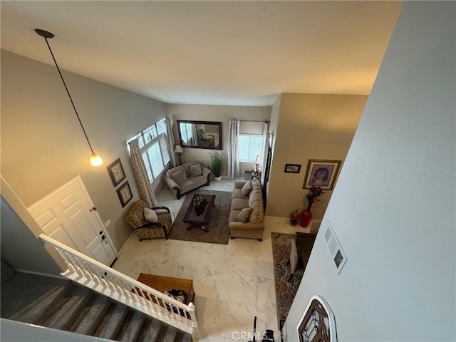 living room with baseboards and marble finish floor