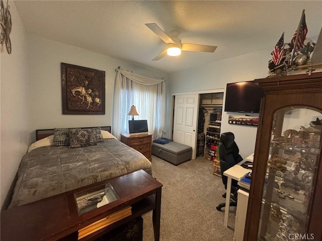 carpeted bedroom featuring a closet and a ceiling fan