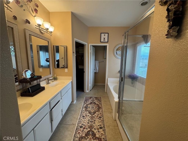 full bathroom with double vanity, a bath, tile patterned floors, a sink, and a stall shower