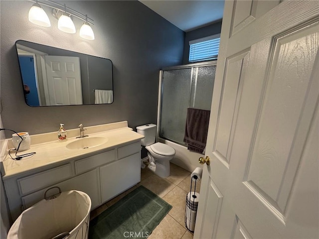 bathroom with toilet, tile patterned floors, bath / shower combo with glass door, and vanity