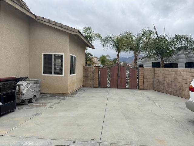 view of patio / terrace featuring a gate and fence