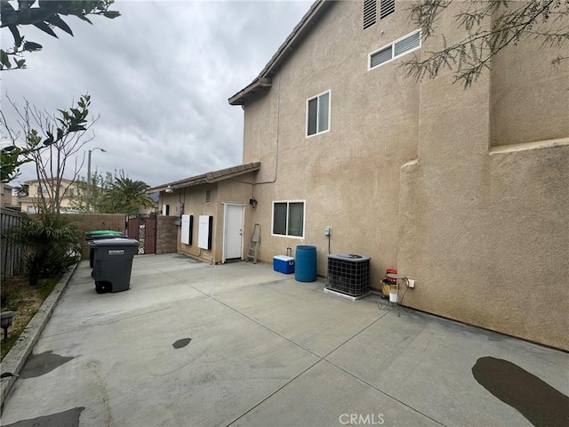 back of property with a patio, a fenced backyard, stucco siding, and cooling unit