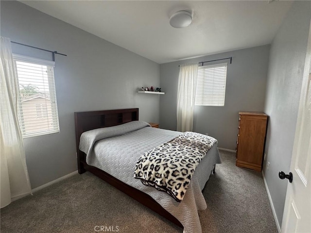 bedroom featuring baseboards, multiple windows, and carpet flooring