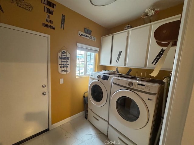 washroom featuring baseboards, marble finish floor, cabinet space, and washer and clothes dryer