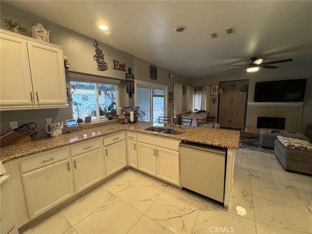 kitchen featuring white cabinets, a sink, dishwasher, marble finish floor, and visible vents