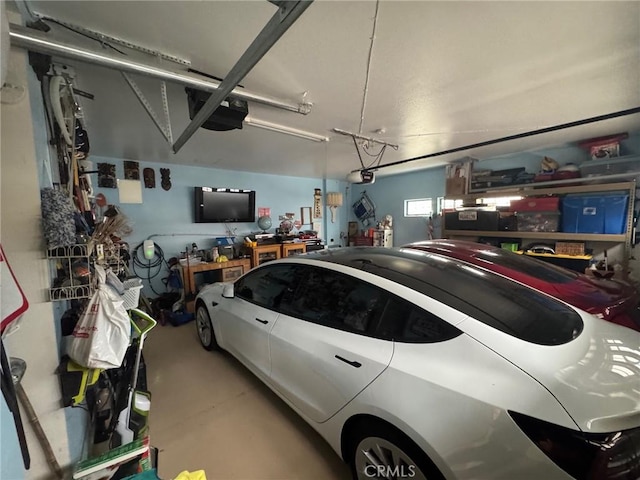 garage with a workshop area and a garage door opener