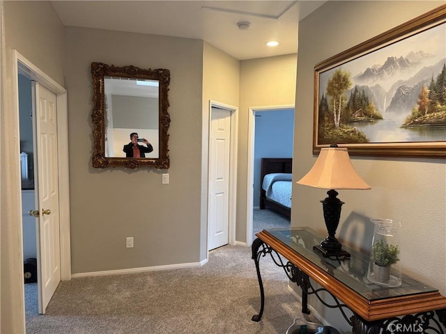 hallway with baseboards and carpet flooring