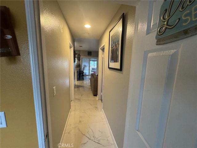hall with baseboards, recessed lighting, and marble finish floor