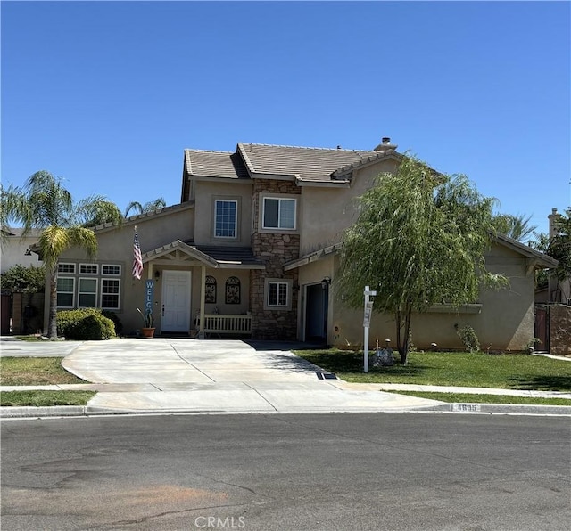 4605 Butterfield Way, Hemet, CA 92544 - traditional-style house featuring stucco siding, stone siding, driveway, and a garage