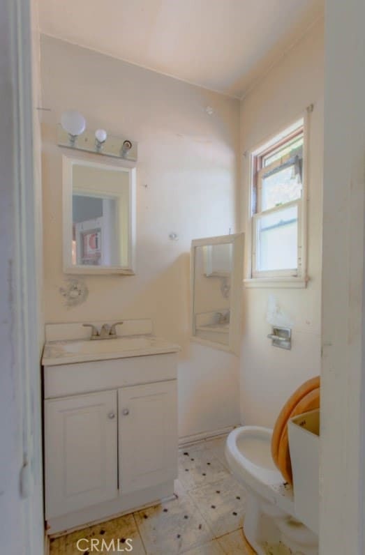 bathroom featuring toilet and vanity