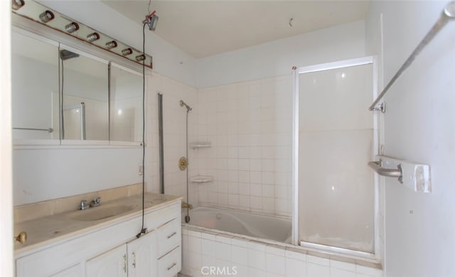 bathroom with vanity and tiled shower / bath combo
