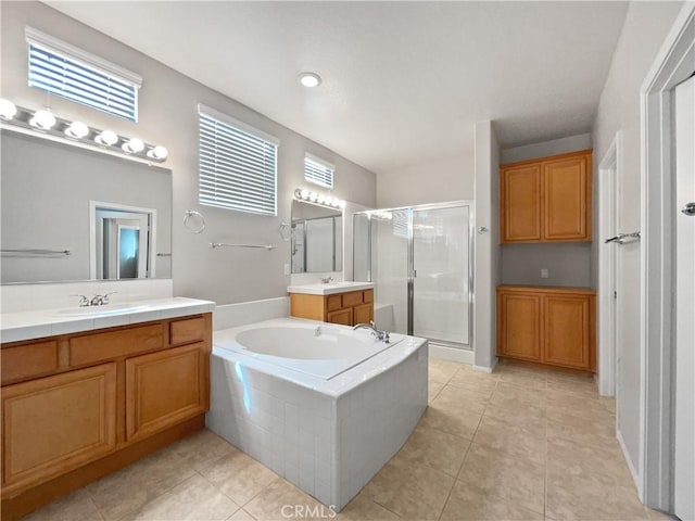 full bath with a garden tub, a sink, tile patterned flooring, and a shower stall
