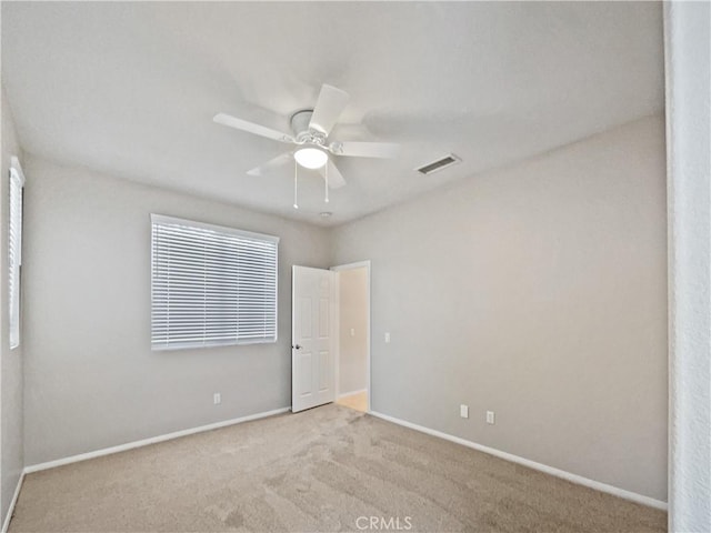 unfurnished bedroom with visible vents, a ceiling fan, baseboards, and carpet floors