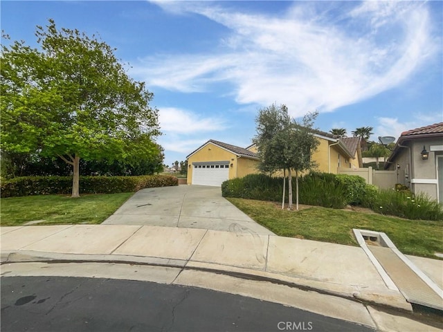 view of property hidden behind natural elements featuring driveway, a front yard, a garage, fence, and stucco siding