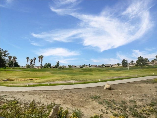 view of community featuring a yard and golf course view