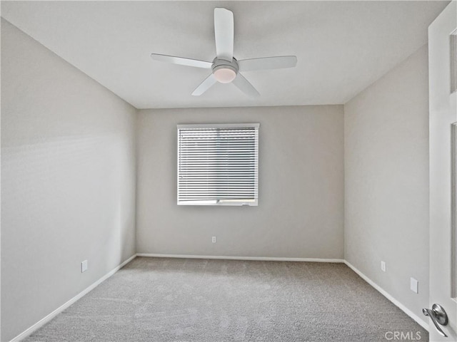 spare room with baseboards, ceiling fan, and carpet flooring