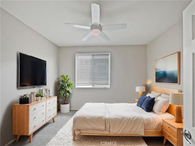 carpeted bedroom with baseboards and a ceiling fan