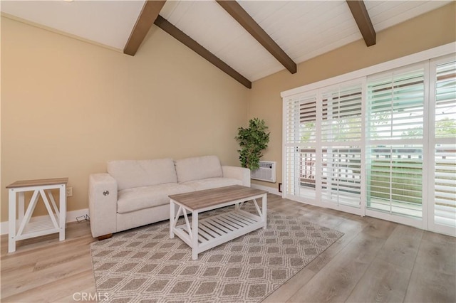 living area featuring baseboards, lofted ceiling with beams, and light wood-style flooring