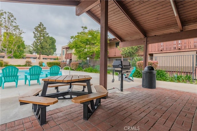 view of patio featuring a fenced in pool, fence, and grilling area