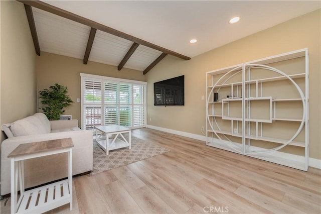 interior space with recessed lighting, lofted ceiling with beams, baseboards, and wood finished floors