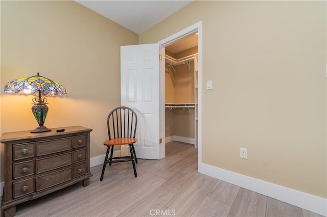 living area with light wood finished floors and baseboards