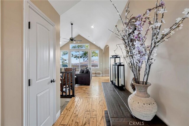 1119 Brentwood Dr, Lake Arrowhead, CA 92352 - hallway with arched walkways, baseboards, vaulted ceiling, and hardwood / wood-style floors