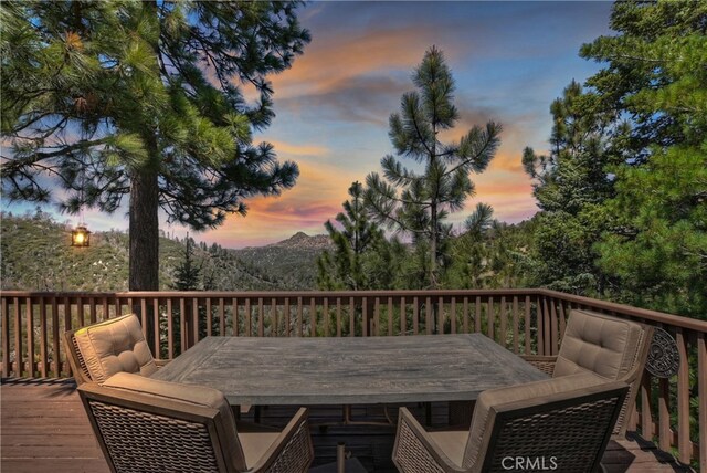 1119 Brentwood Dr, Lake Arrowhead, CA 92352 - wooden deck featuring outdoor dining area and a mountain view