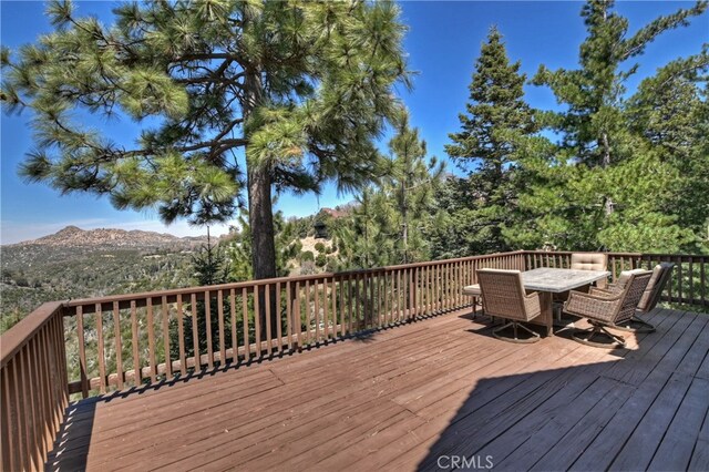 1119 Brentwood Dr, Lake Arrowhead, CA 92352 - wooden deck featuring a mountain view and outdoor dining area