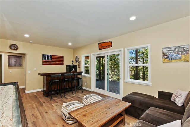 1119 Brentwood Dr, Lake Arrowhead, CA 92352 - living room with healthy amount of natural light, light wood-style flooring, baseboards, recessed lighting, and a bar