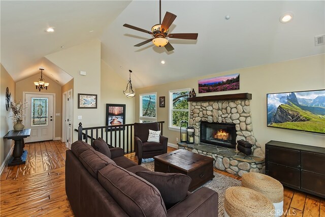 1119 Brentwood Dr, Lake Arrowhead, CA 92352 - living room featuring hardwood / wood-style flooring, baseboards, ceiling fan, a stone fireplace, and a chandelier