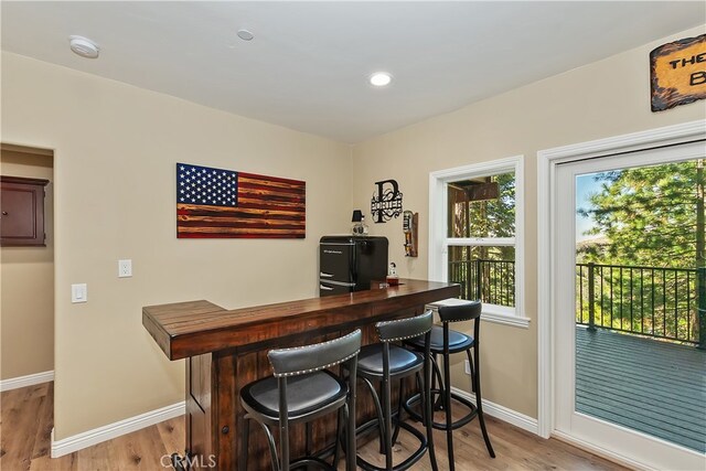 1119 Brentwood Dr, Lake Arrowhead, CA 92352 - bar area featuring baseboards, light wood-style flooring, refrigerator, and recessed lighting