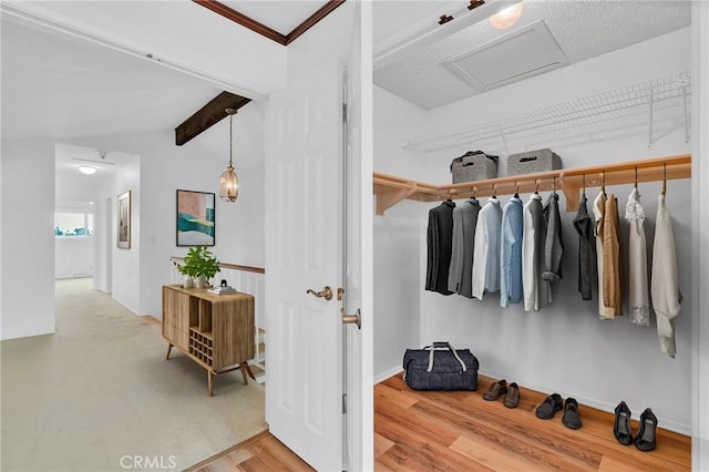 8913 La Dona Ct, Fountain Valley, CA 92708 - walk in closet featuring vaulted ceiling with beams, attic access, and wood finished floors