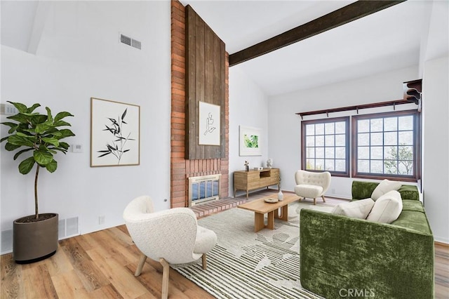 8913 La Dona Ct, Fountain Valley, CA 92708 - living area with a fireplace, visible vents, beam ceiling, and wood finished floors