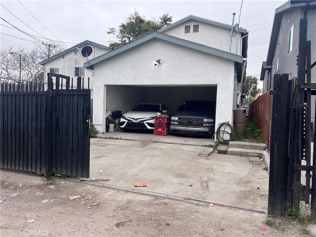 exterior space featuring fence and concrete driveway