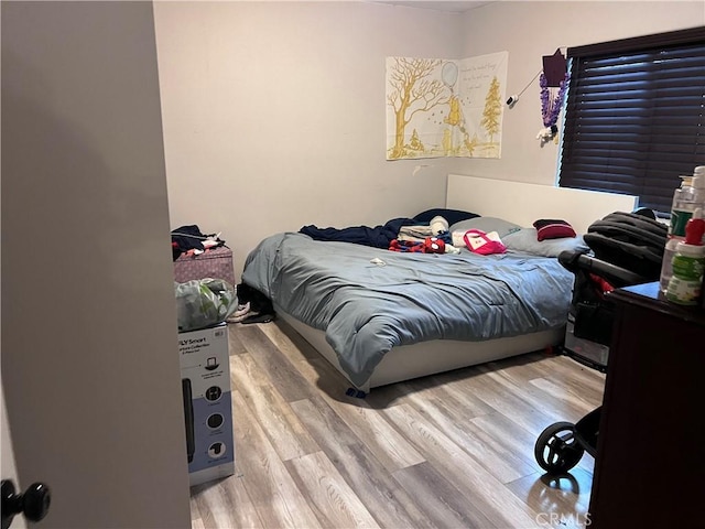 bedroom with wood finished floors