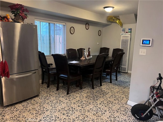 dining area featuring baseboards and a heating unit