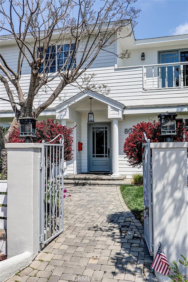 view of front of property featuring fence and a gate