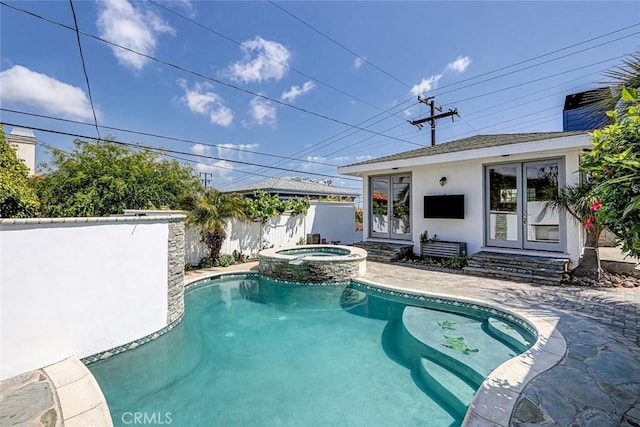 view of pool featuring a patio, a pool with connected hot tub, fence, and french doors