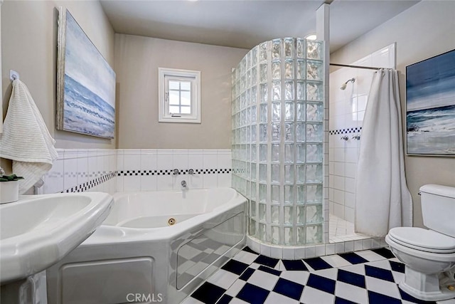 bathroom featuring a walk in shower, toilet, tile patterned floors, and a bath