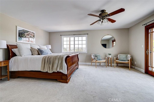 carpeted bedroom featuring baseboards and ceiling fan