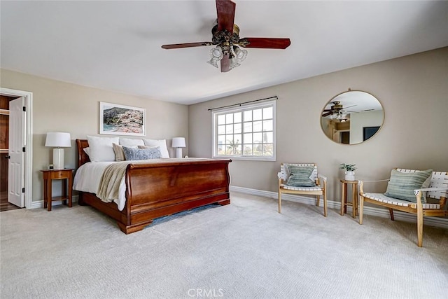 carpeted bedroom featuring baseboards and a ceiling fan